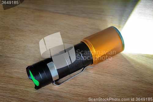 Image of Included electric torch with a beam of light.