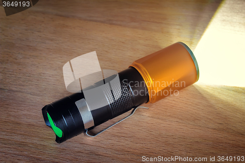 Image of Included electric torch with a beam of light.