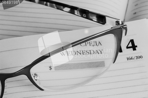 Image of Glasses and notebook .