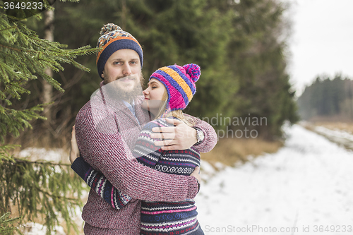 Image of Young couple hugging in winter forest