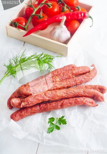 Image of sausages in paper, vegetables in the box