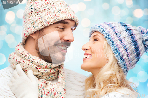 Image of smiling couple in winter clothes hugging