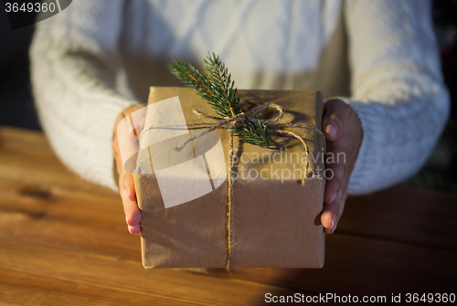 Image of close up of woman with christmas gift or parcel