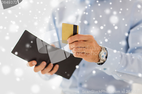 Image of close up of man holding wallet and credit card