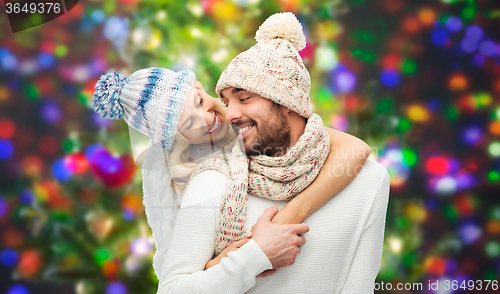 Image of smiling couple in winter clothes hugging