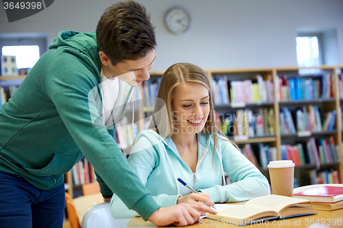 Image of happy students preparing to exams in library