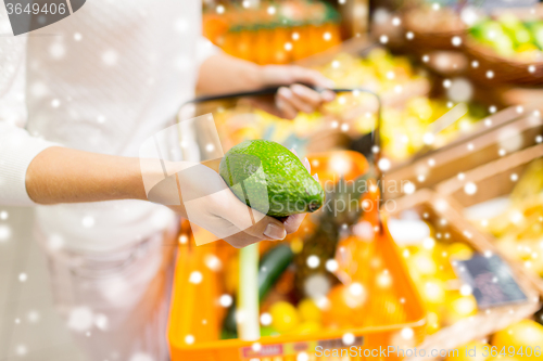 Image of close up of woman with food basket in market