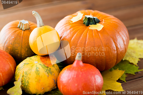 Image of close up of pumpkins on wooden table at home