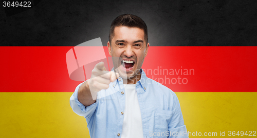 Image of angry man pointing finger on you over german flag