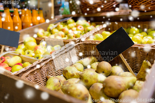 Image of fruits in baskets with nameplates at food market