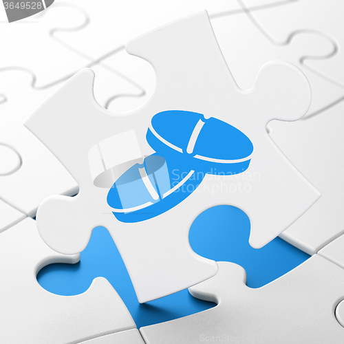 Image of Healthcare concept: Pills on puzzle background