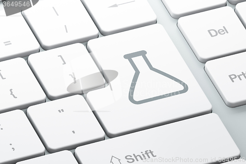 Image of Science concept: Flask on computer keyboard background