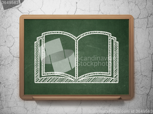 Image of Science concept: Book on chalkboard background