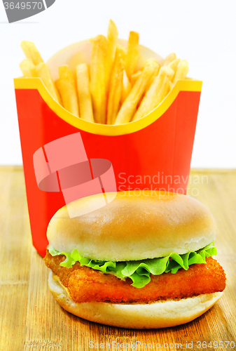 Image of Burger with fries and fish  