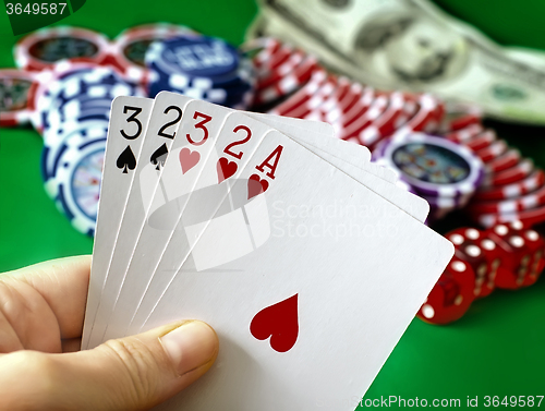 Image of Card for poker in the hand, chips and card for poker