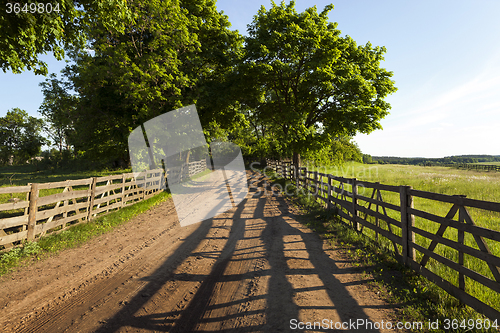 Image of   Dirt road in the rural area  wooden fence