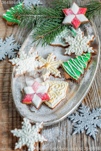 Image of Tray of Christmas cookies and spruce branches.