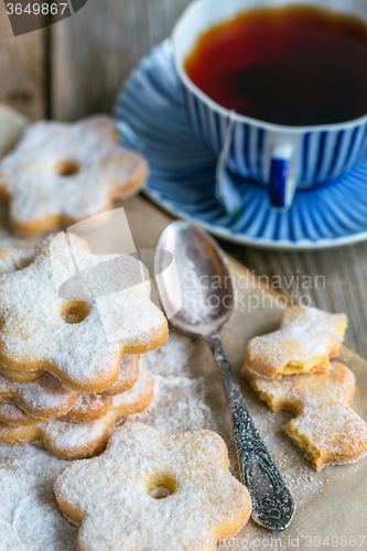 Image of Italian cookies, spoon and a cup of tea.