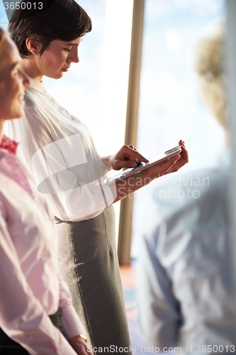 Image of business woman working on tablet computer