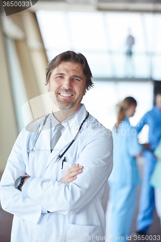 Image of group of medical staff at hospital, handsome doctor in front of 