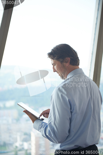 Image of handosme business man working on tablet