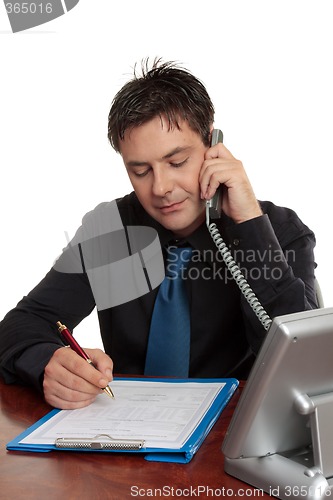 Image of Businessman or doctor filling out form