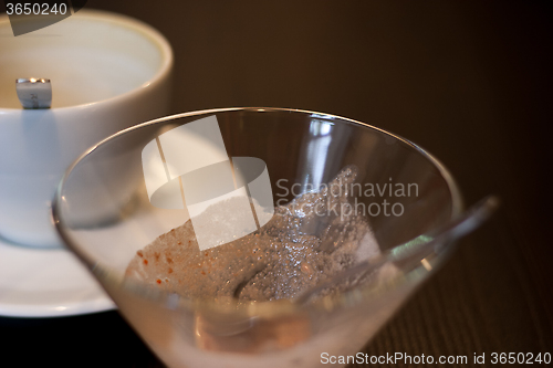 Image of empty coffee cup and vase out of ice cream