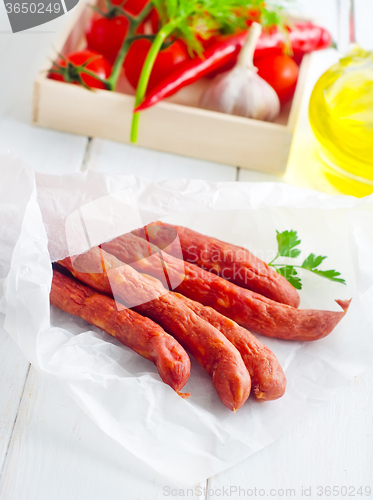 Image of sausages in paper, vegetables in the box