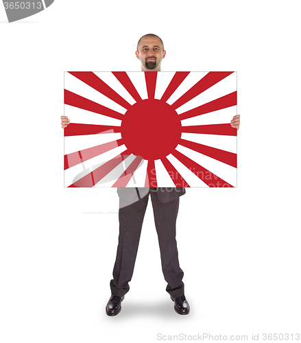 Image of Smiling businessman holding a big card, flag of Japan