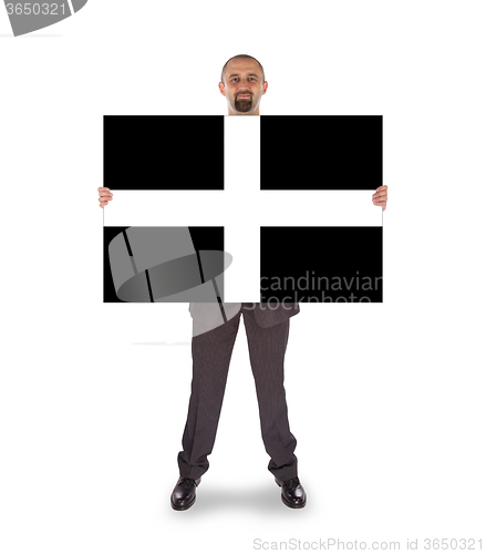 Image of Smiling businessman holding a big card, flag of Cornwall