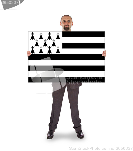 Image of Smiling businessman holding a big card, flag of Brittany