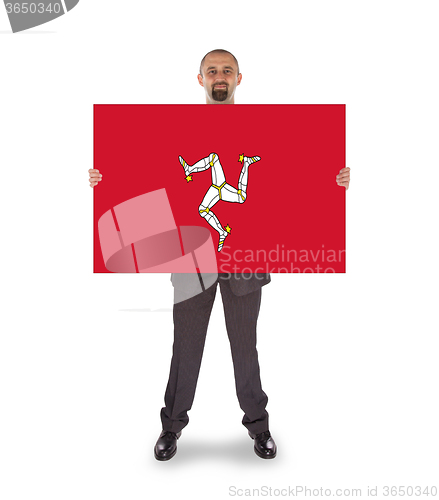 Image of Smiling businessman holding a big card, flag of Isle of Man