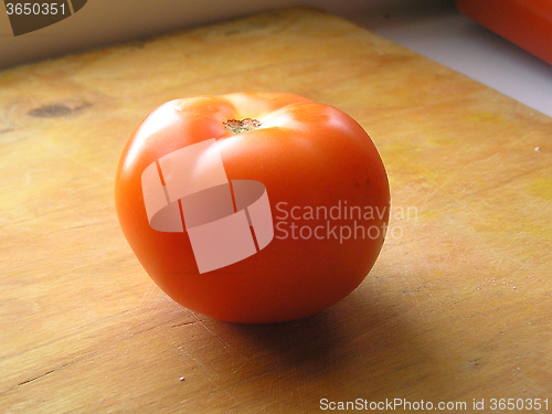 Image of tomato on wooden board