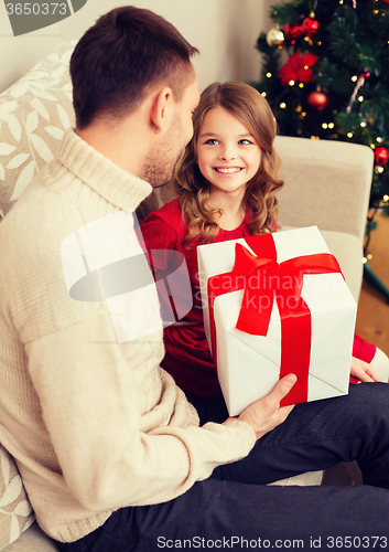 Image of smiling father and daughter looking at each other