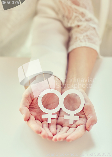 Image of close up of happy lesbian couple with venus symbol