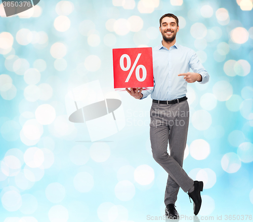 Image of smiling man with red shopping bag over blue lights