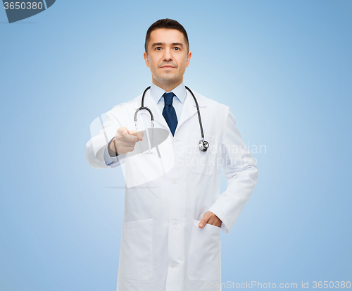 Image of male doctor in white coat pointing at you