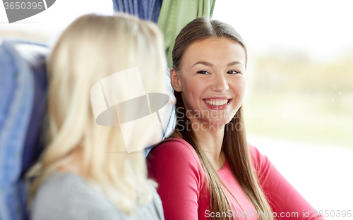 Image of happy young women sitting in travel bus