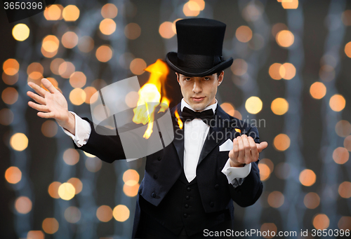 Image of magician in top hat showing trick