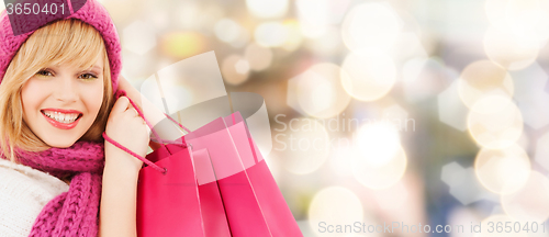 Image of smiling young woman with shopping bags