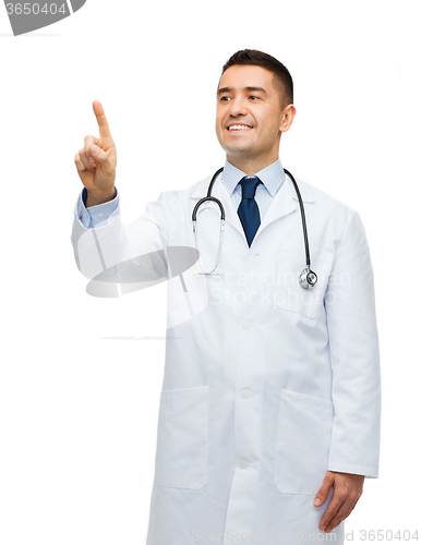 Image of smiling male doctor in white coat pointing finger