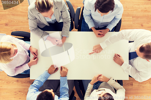 Image of close up of business team sitting at table