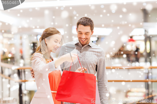 Image of happy young couple with shopping bag in mall