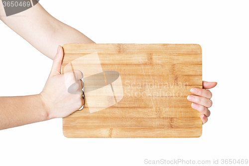 Image of hands holding chopping board