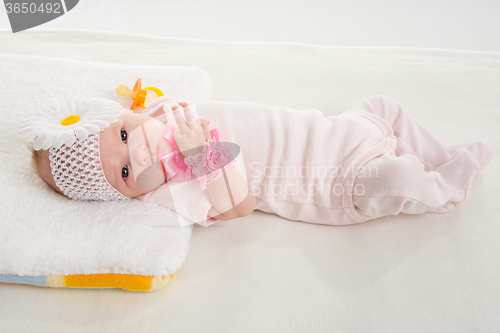 Image of The two-month girl lying on the bed