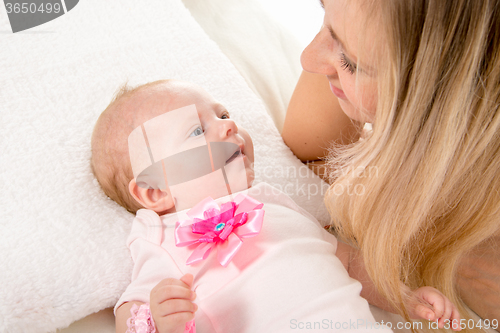 Image of Mom and two-month baby looking at each other