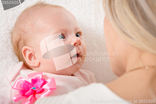 Image of The two-month baby looking at his mother