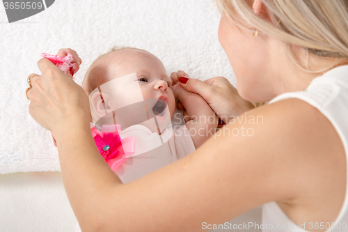 Image of Mom is looking at a two-month girl with an open mouth