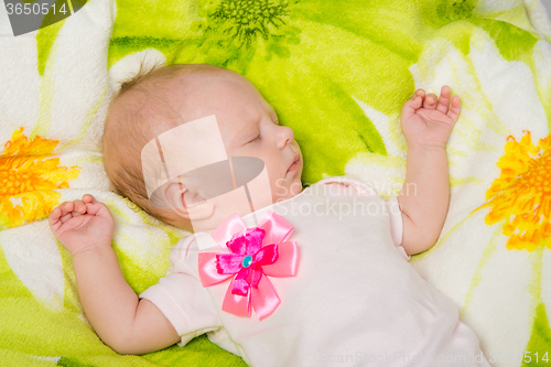 Image of The two-month baby carefree sleeping on the bed