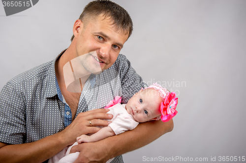 Image of Happy dad is holding a two-month girl